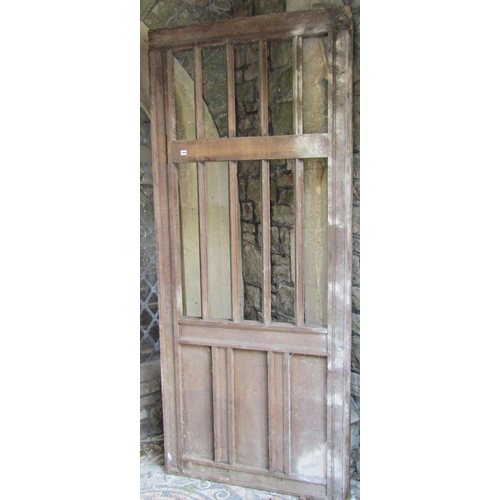 1099 - An antique oak architectural panel or door, partially open with moulded vertical doors, 236cm high x... 