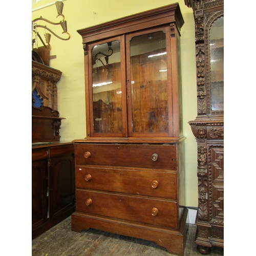 1667 - A simple 19th century secretarie bookcase in oak, the lower section fitted with three drawers, the u... 