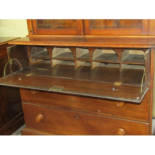 1667 - A simple 19th century secretarie bookcase in oak, the lower section fitted with three drawers, the u... 