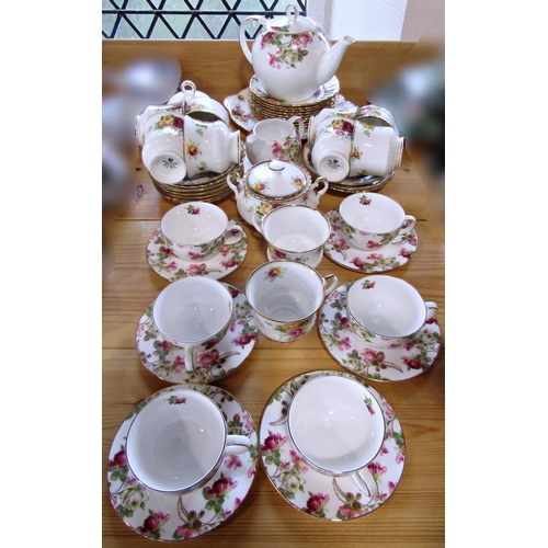 11 - A Royal Stafford Rose pattern tea service for eight, together with a further oriental tea service wi... 