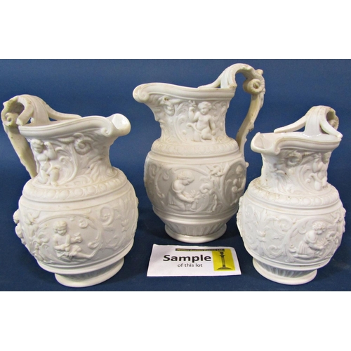 18 - Three Victorian white ground smear glazed graduated jugs with cupid and other detail, two individual... 