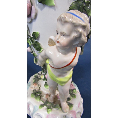 20 - A 19th century continental porcelain oil lamp frame, the oviform font supported by two cherubs, with... 