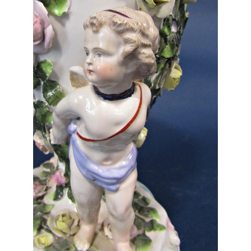 20 - A 19th century continental porcelain oil lamp frame, the oviform font supported by two cherubs, with... 