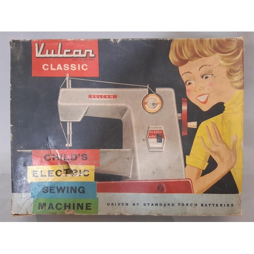 557 - Vintage child's sewing machine 'Vulcan classic' with instructions, extension work table and clamp, i... 