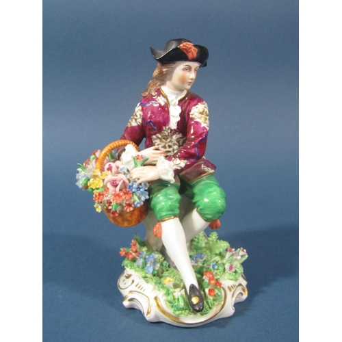 73 - A Sitzendorf figure of a seated gentleman with a basket of flowers and floral encrusted decoration w... 