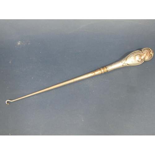 188 - A silver handled button hook with cherub decoration, London 1896, makers mark rubbed, 34.5cm long