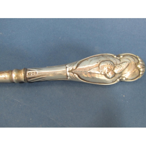 188 - A silver handled button hook with cherub decoration, London 1896, makers mark rubbed, 34.5cm long