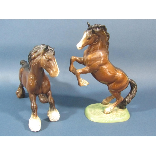 75 - A collection of Beswick horses comprising rearing example, mare and foal and a shire horse example