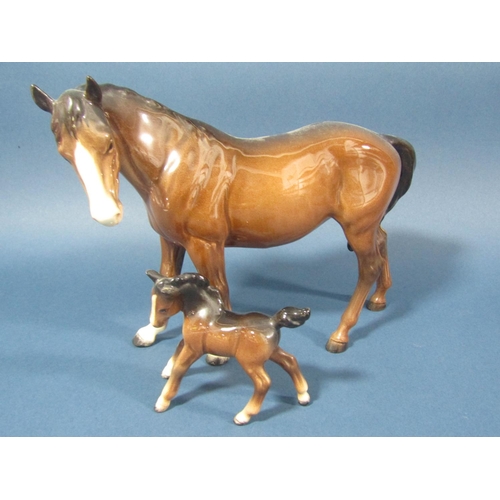 75 - A collection of Beswick horses comprising rearing example, mare and foal and a shire horse example