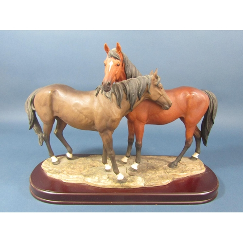 79 - A Leonardo Collection resin figure group of two horses, 41cm long x 29cm tall approx