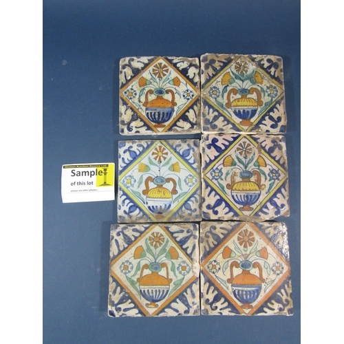 88 - A collection of 40 antique Isnic ceramics tiles, with repeating detail centered around a vase of flo... 