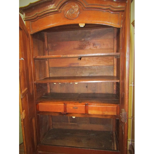 1543 - 18th century cherrywood armoire enclosed by a pair of shaped and panelled doors over a single frieze... 