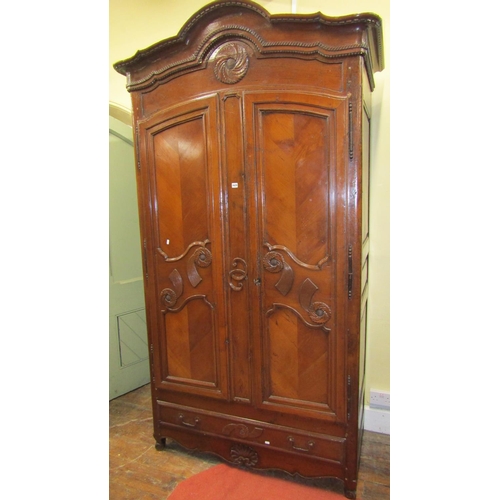 1543 - 18th century cherrywood armoire enclosed by a pair of shaped and panelled doors over a single frieze... 