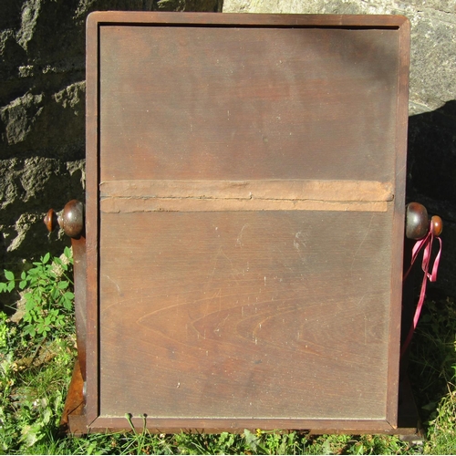 1562 - A Victorian mahogany toilet mirror, the platform base with shaped outline on scrolled toes