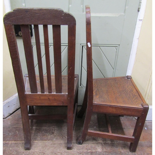 1566 - Pair of old English oak rail back dining chairs with solid seats, with carved detail incorporating n... 