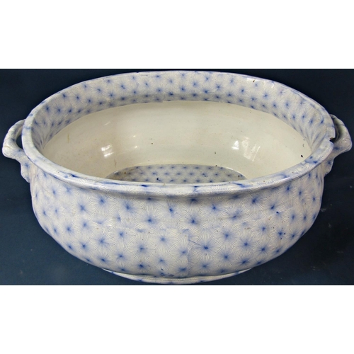 108 - A large water jug and two handled rectangular footbath set with all over blue printed 'star' geometr... 