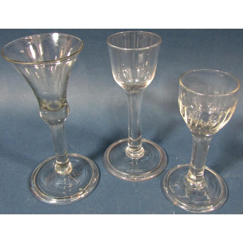 115 - Four Georgian solid stemmed wine glasses of varying design , a flared conical wine glass with waiste... 