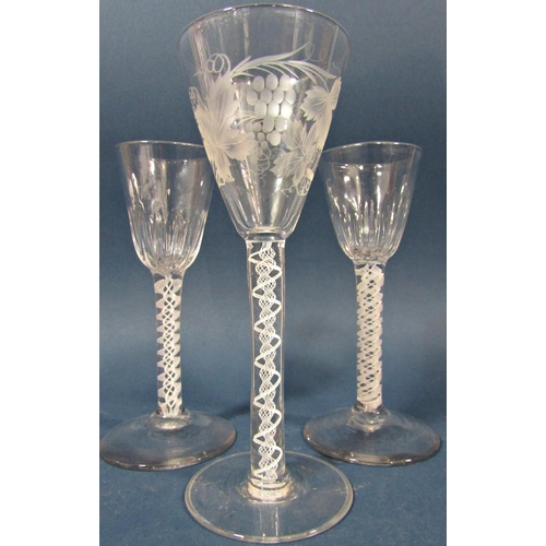 121 - Two Georgian  conical grape and vine engraved wine glasses with double spiral and helix air blown st... 