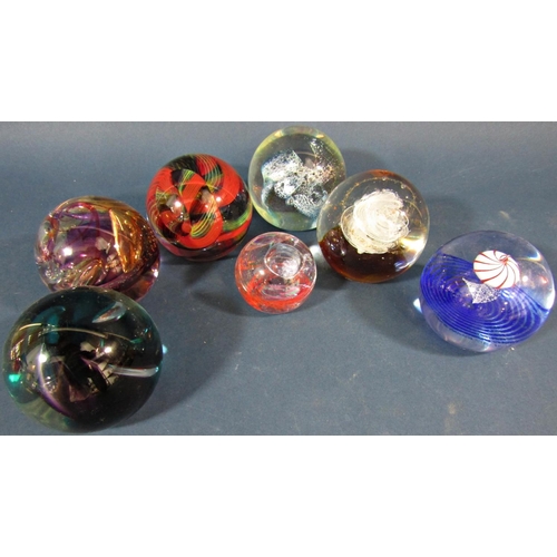 125 - Twelve Caithness paperweights of varying shapes and sizes, a red glass vase and a cut glass scent bo... 