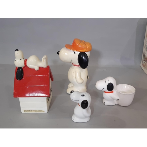 598 - A collection of Snoopy merchandise including ceramic kennel moneybox, socks, sets of drinking glasse... 