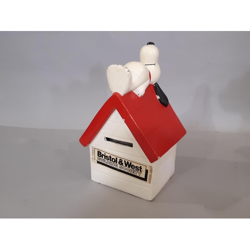 598 - A collection of Snoopy merchandise including ceramic kennel moneybox, socks, sets of drinking glasse... 