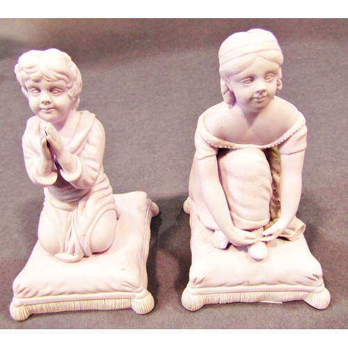 69 - Two Minton Parian figures of children in kneeling poses, the boy praying, the girl tying her shoe la... 