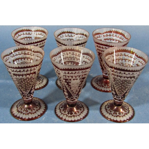 135 - Six red engraved conical shaped liqueur glasses.