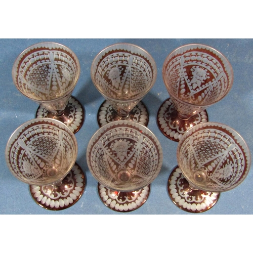 135 - Six red engraved conical shaped liqueur glasses.