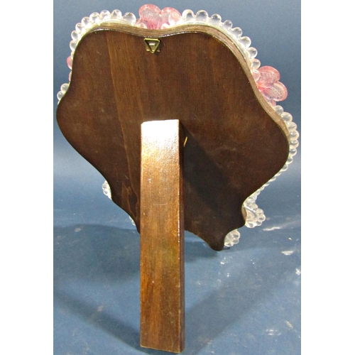 136 - A Venetian glass toilet mirror with pink petal detail to beaded and scrolled glass frame enclosing e... 