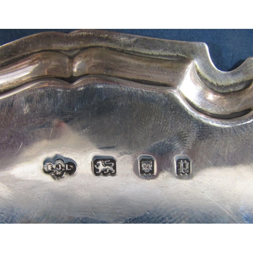 189 - A small silver tray with shaped edge, raised on three pad feet, London 1930, maker Ernest J Lowe, 15... 