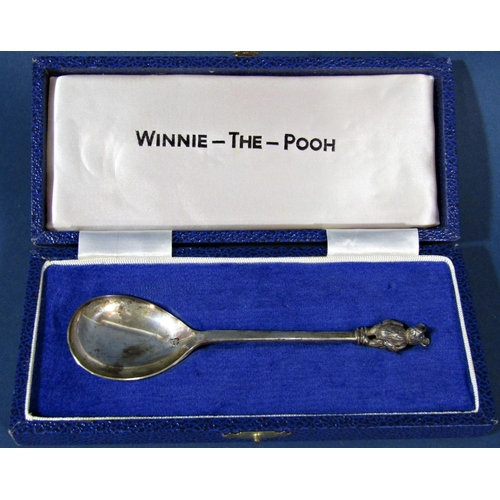 199 - A silver Winnie-the-Pooh christening spoon with original case, a small circular silver photo frame, ... 