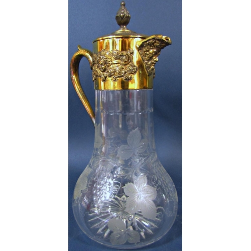 204 - An Asprey silver gilt bacchanalian decorated claret jug with engraved grape and vine glass, 33cm hig... 