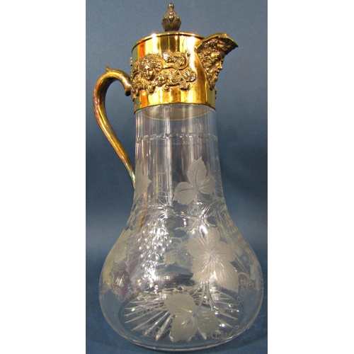 204 - An Asprey silver gilt bacchanalian decorated claret jug with engraved grape and vine glass, 33cm hig... 