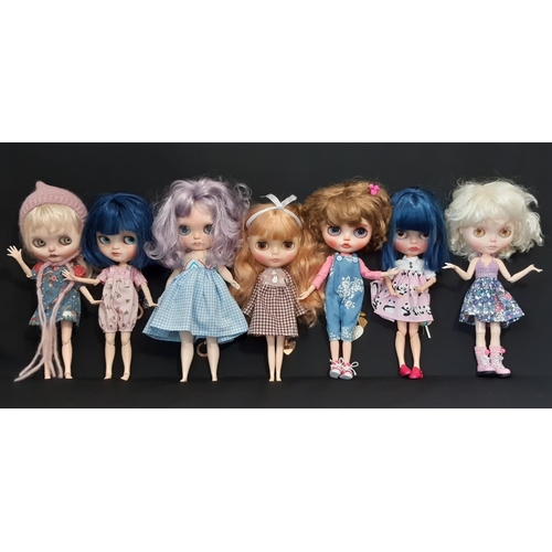 584 - A mixed group of seven 21st century customised Blythe type dolls; all have colour changing eyes oper... 