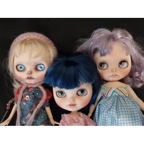 584 - A mixed group of seven 21st century customised Blythe type dolls; all have colour changing eyes oper... 