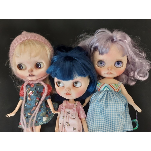 584 - A mixed group of seven 21st century customised Blythe type dolls; all have colour changing eyes oper... 