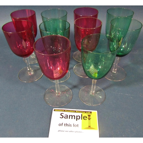 144 - Twenty five cranberry red baluster wine glasses on slender stems, and eight green baluster wine glas... 