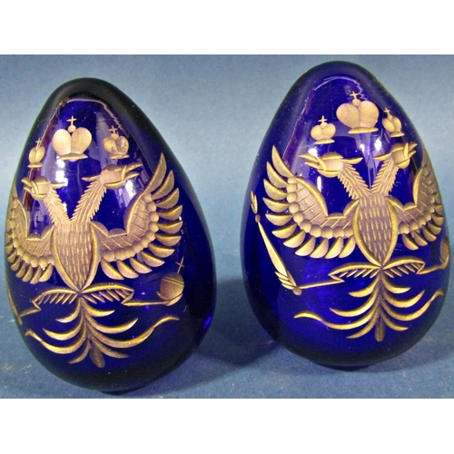 147 - A pair of cobalt blue cut glass gilded Faberge style Easter eggs both bearing the Russian Imperial d... 