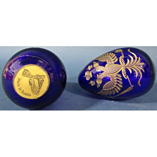 147 - A pair of cobalt blue cut glass gilded Faberge style Easter eggs both bearing the Russian Imperial d... 