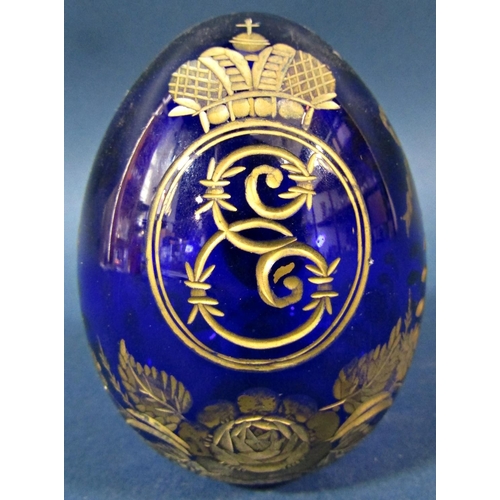 150 - A single cobalt blue cut glass and gilded Faberge style Easter egg bearing an Imperial monogram and ... 