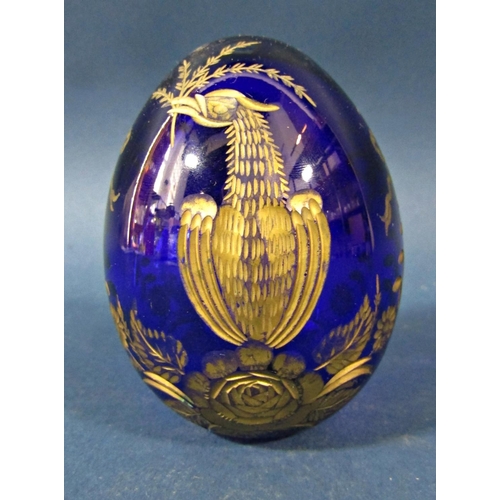 150 - A single cobalt blue cut glass and gilded Faberge style Easter egg bearing an Imperial monogram and ... 