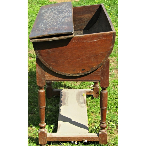 1219 - An 18th century oak dough bin with hinged lid, raised/cradled on a stand with turned supports united... 