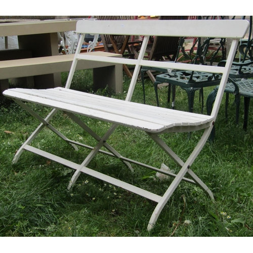 1018 - A cream painted folding square tubular steel framed two seat garden bench with wooden slatted seat a... 