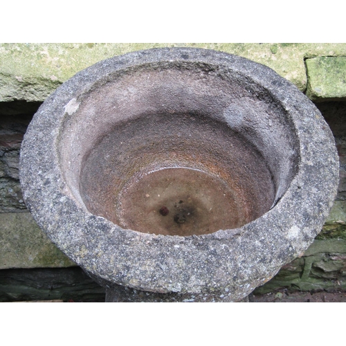 1024 - A pair of weathered cast composition stone garden urns with circular lobed bowls with fixed socles a... 