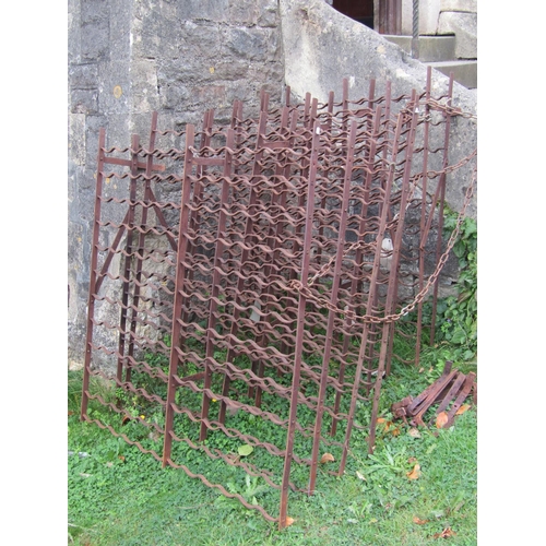 1045 - Five antique ironwork wine racks of varying sizes, 3 to hold 120 bottles, 1 to hold 99 bottles and 1... 