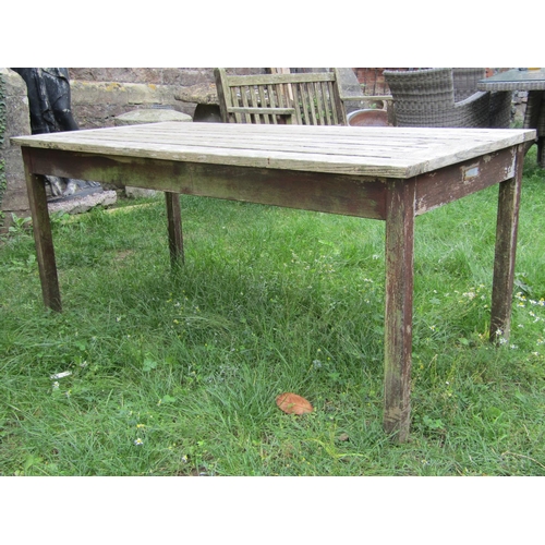 1060a - A Britannic stained teak garden table of rectangular form with slatted top and square cut supports, ... 