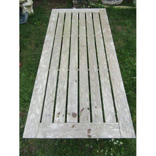 1060a - A Britannic stained teak garden table of rectangular form with slatted top and square cut supports, ... 