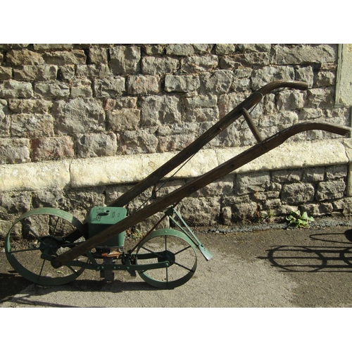 1099 - A vintage Planet Junior seed drill no.300, with two spoke wheels and wooden shafts/handle