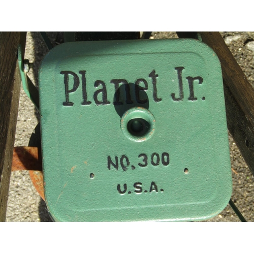 1099 - A vintage Planet Junior seed drill no.300, with two spoke wheels and wooden shafts/handle