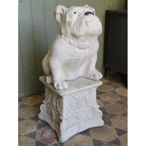 1107 - A cast composition stone garden ornament in the form of a seated bulldog raised on associated pedest... 